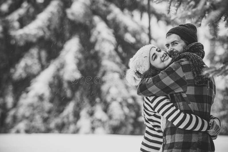 Couples heureux de Noël dans l'amour dans la forêt froide d'hiver neigeux photos libres de droits Couples heureux de Noël dans l'amour dans la forêt froide d'hiver neigeux photos libres de droits