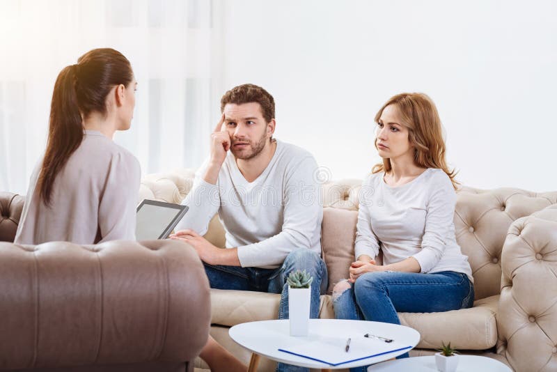 Couples malheureux tristes écoutant le psychologue images libres de droits