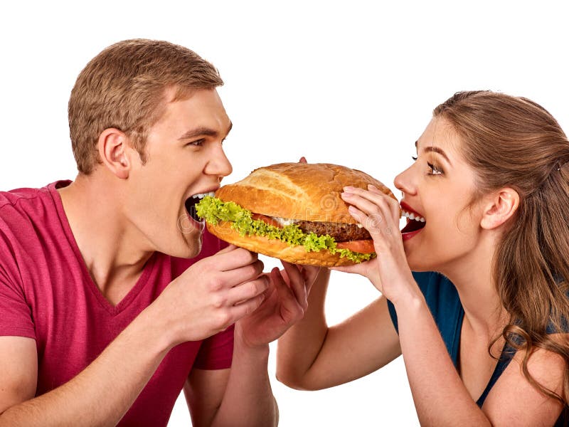 Couples mangeant des aliments de préparation rapide Hamburger de festin d'homme et de femme image libre de droits Couples mangeant des aliments de préparation rapide Hamburger de festin d'homme et de femme image libre de droits