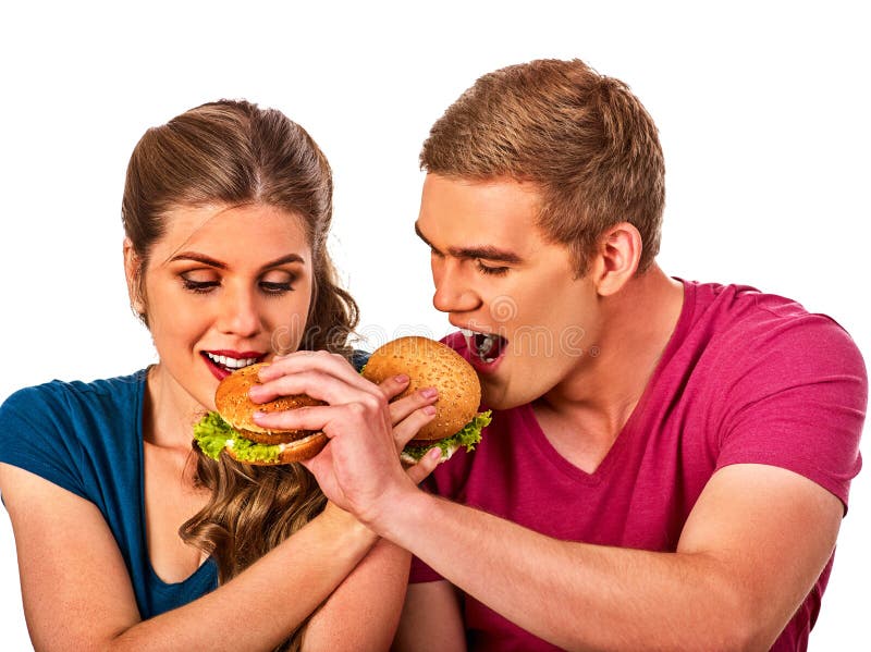 Couples mangeant des aliments de préparation rapide L'homme et la femme mangent l'hamburger photographie stock libre de droits Couples mangeant des aliments de préparation rapide L'homme et la femme mangent l'hamburger photographie stock libre de droits