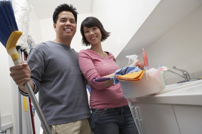 Portrait of happy couple ready to clean the house. Portrait of happy couple ready to clean the house