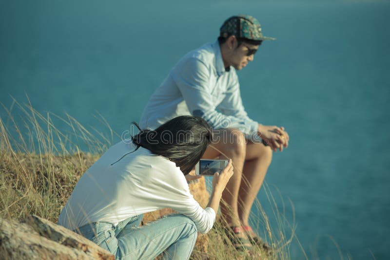 Couples of younger man and woman taking photo by smart phone royalty free stock photo Couples of younger man and woman taking photo by smart phone royalty free stock photo