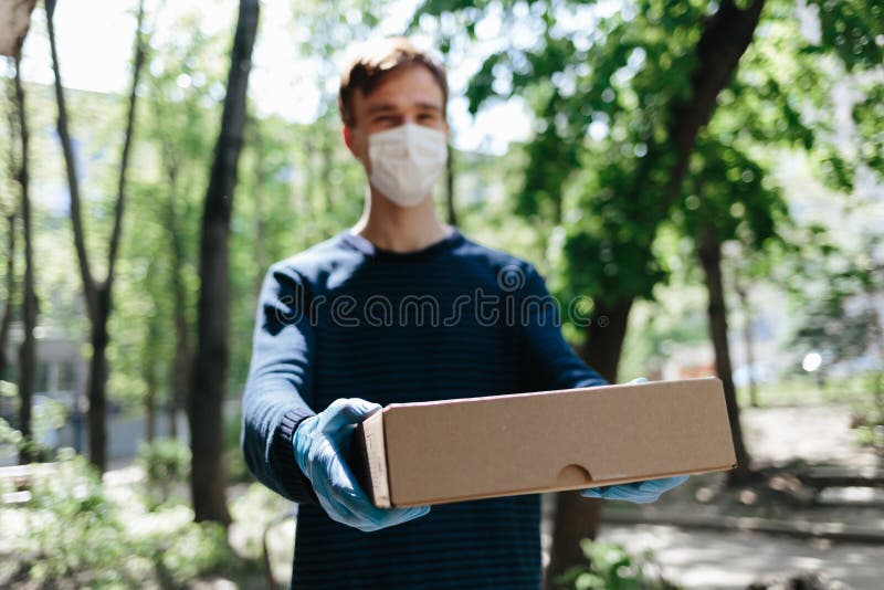 Courier Delivery Man In Medical Latex Gloves And Mask Safely