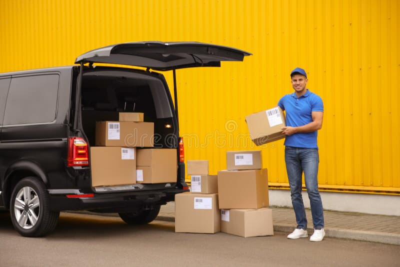 Courier with parcels near delivery van outdoors royalty free stock photos