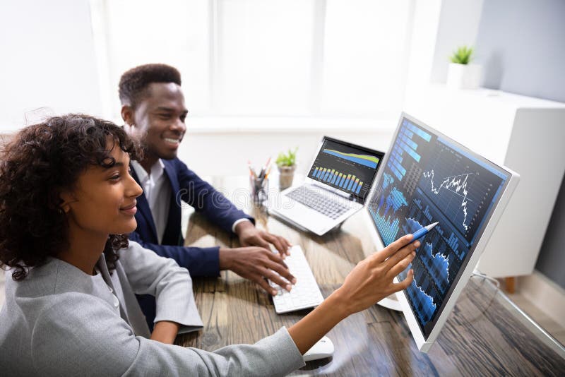 Stock Market Broker Analyzing Graphs On Computer In Office. Stock Market Broker Analyzing Graphs On Computer In Office