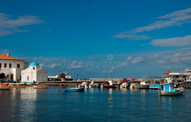 Cove of Mykonos town with fishing boats and church