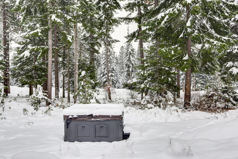 Covered outdoor hot tub surrounded by snow