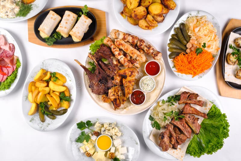 A Covered Table with Many Different Dinner Dishes. Lots of Food on a