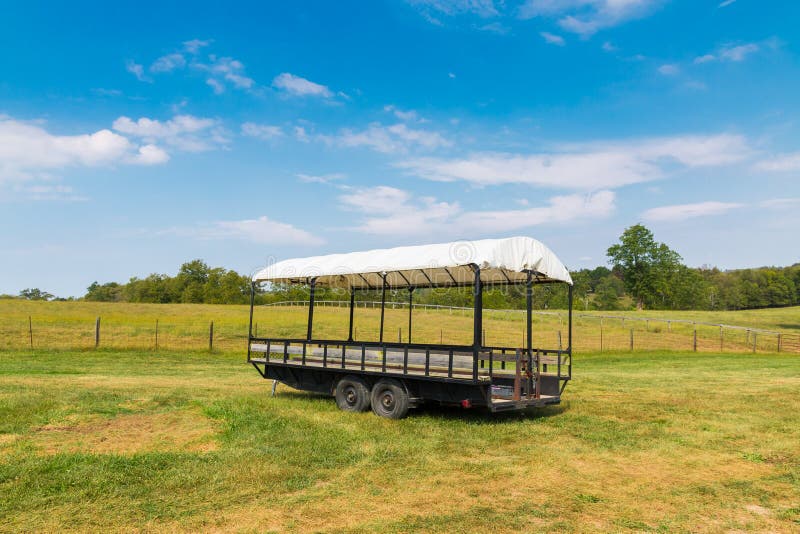 A Farm Hay Wagon Filled With Silage Waiting On The Edge Of A Farm Field