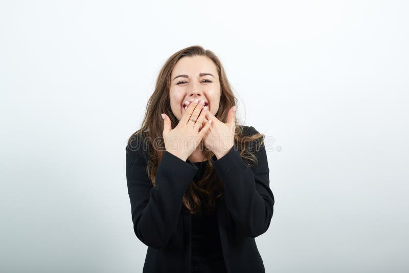A Handsome Kid Giggling Covering His Mouth With His Hands Stock Image