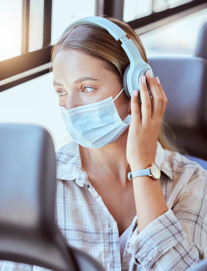 Covid, face mask or headphones on woman in bus for city travel, public transport or location commute. Thinking, fashion. Or relax student in virus compliance stock photo Covid, face mask or headphones on woman in bus for city travel, public transport or location commute. Thinking, fashion. Or relax student in virus compliance stock photo