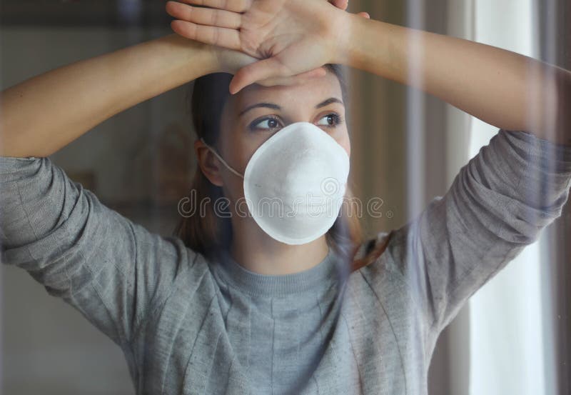 COVID-19 Pandemic Coronavirus Woman Home Isolation Quarantine Wearing Mask Protective Against SARS-CoV-2. Quarantine girl with