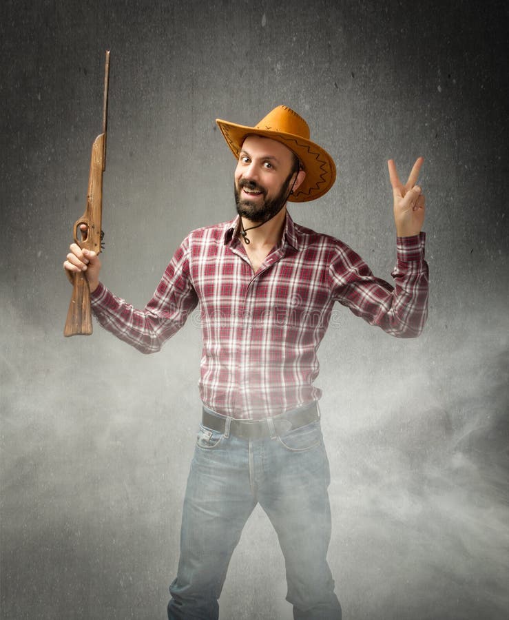 Cow boy in a winning situation with rifle royalty free stock image