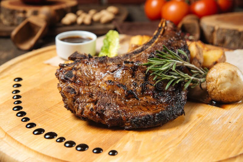 Cowboy Beef Steak on a Wooden Board with Potatoes Stock Photo - Image ...