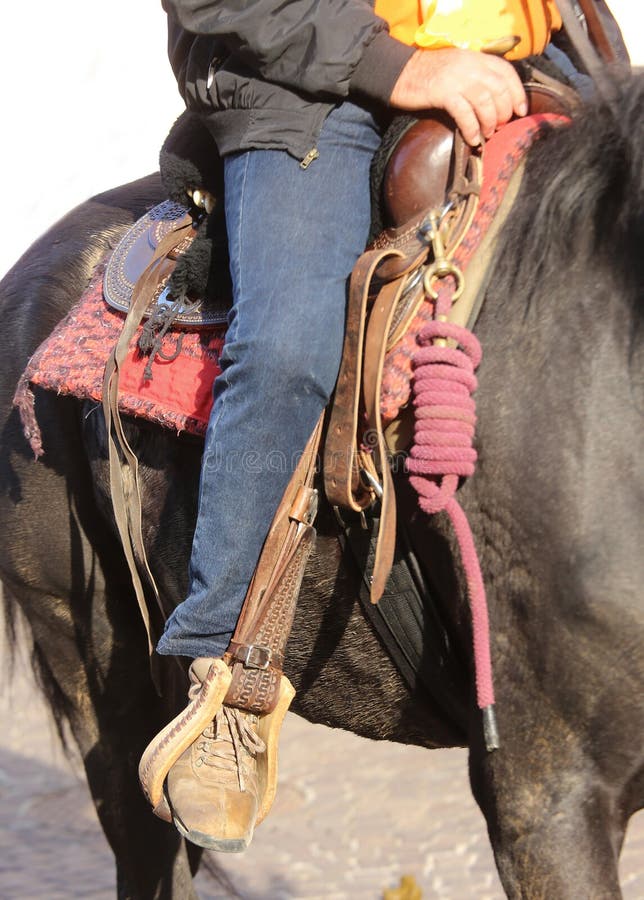 Cowboy Boot in the Stirrup of the Horse during the Ride Stock Image