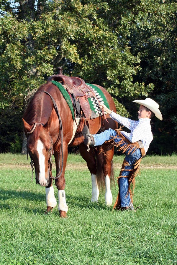 Cowboy mounting his horse