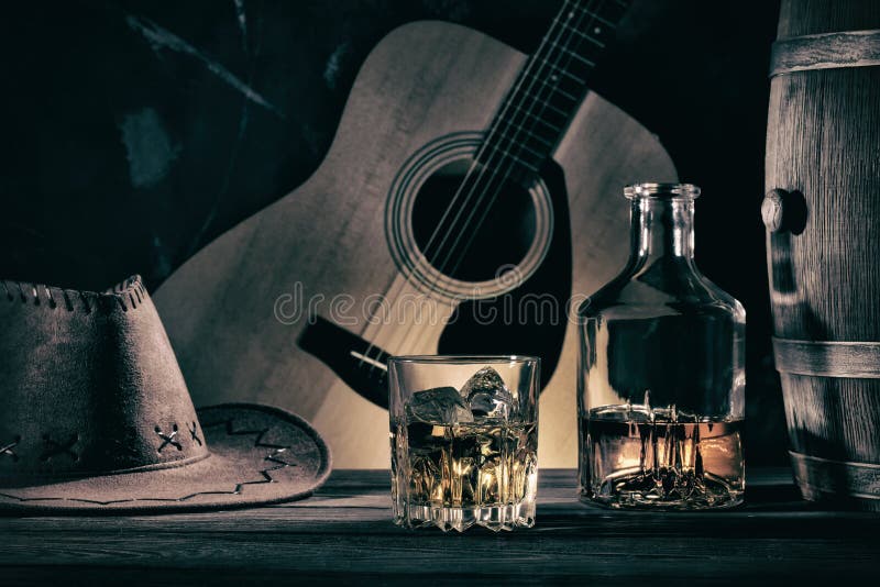 Cowboy Still Life Against Guitar