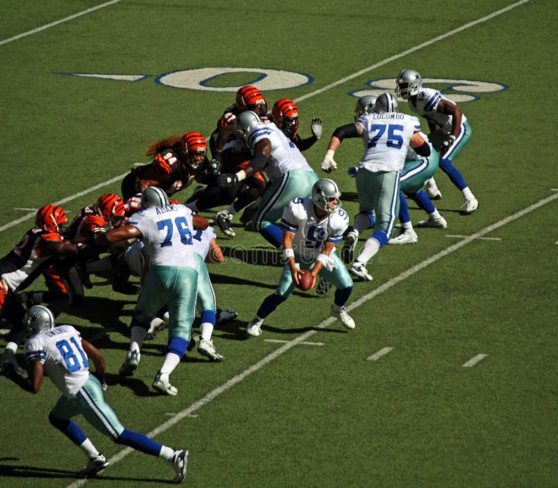 DALLAS - OCT 5: Taken in Texas Staiuim, Irving, Texas on October 5, 2008. Game between the Cowboys and Bengals. Dallas quarterback Tony Romo takes the snap for a hand off. The last year Dallas will play in Texas Stadium. DALLAS - OCT 5: Taken in Texas Staiuim, Irving, Texas on October 5, 2008. Game between the Cowboys and Bengals. Dallas quarterback Tony Romo takes the snap for a hand off. The last year Dallas will play in Texas Stadium.