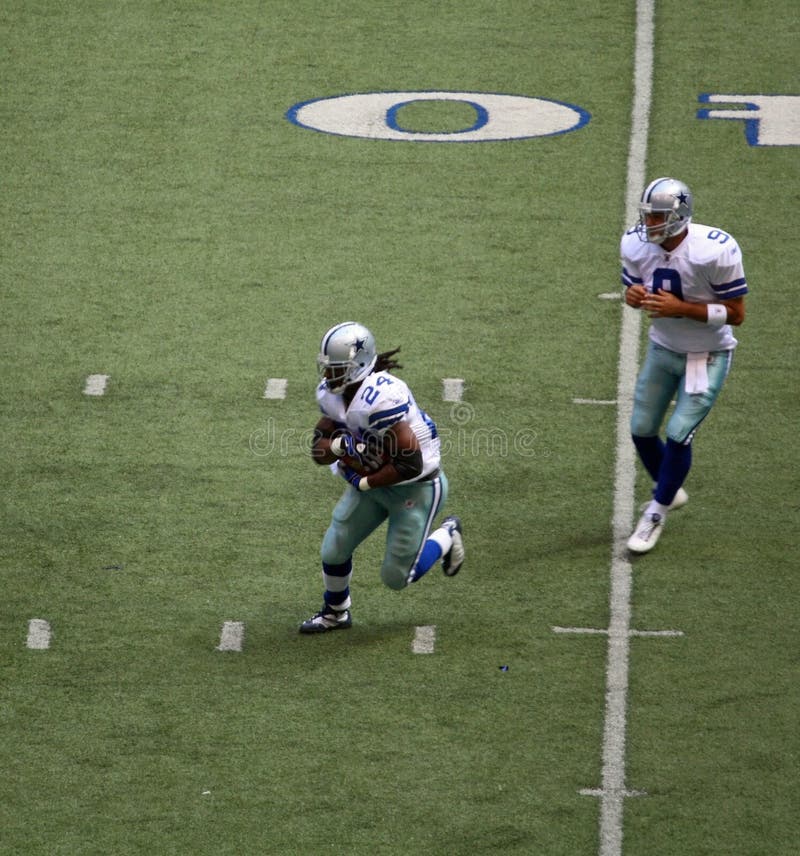 DALLAS - OCT 5: Taken in Texas Stadium in Irving, Texas on Sunday, October 5, 2008. Quarterback Tony Romo hands off to Marion Barber. DALLAS - OCT 5: Taken in Texas Stadium in Irving, Texas on Sunday, October 5, 2008. Quarterback Tony Romo hands off to Marion Barber.