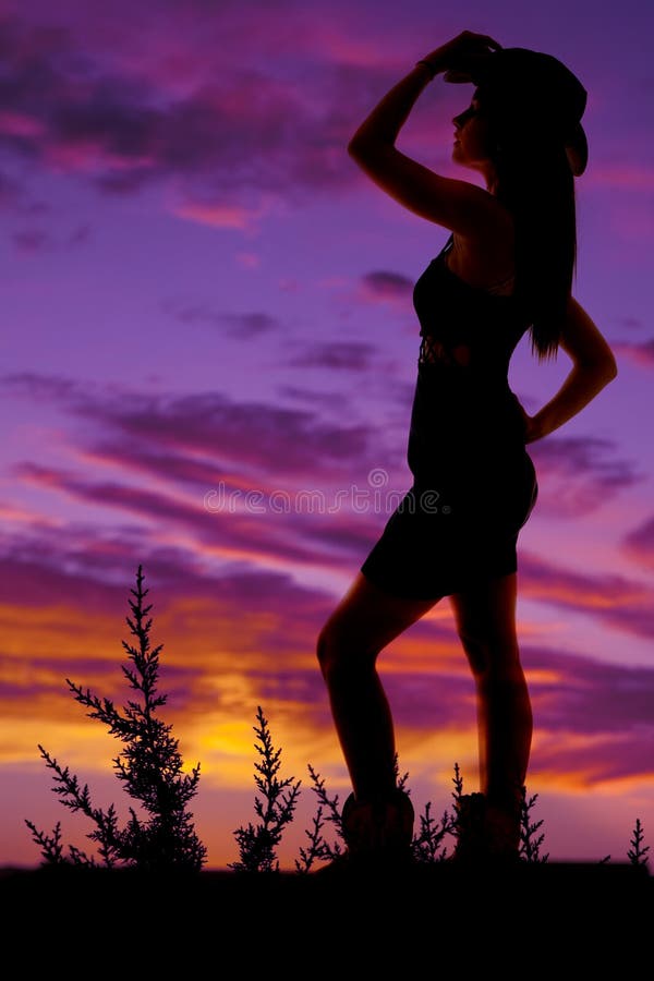 Cowgirl stand hat on head boots standing