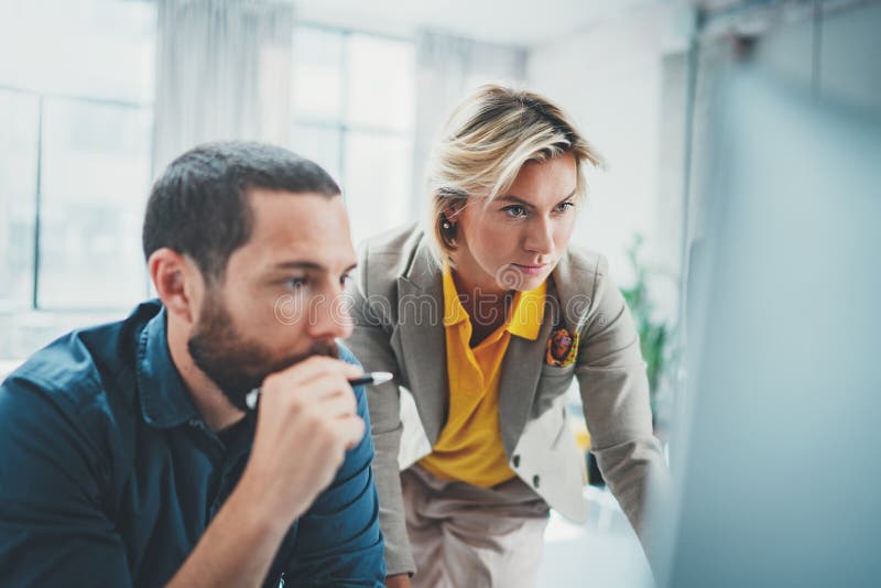 Coworkers team at modern office.Young business crew working with new startup idea studio.Blurred background. royalty free stock images Coworkers team at modern office.Young business crew working with new startup idea studio.Blurred background. royalty free stock images