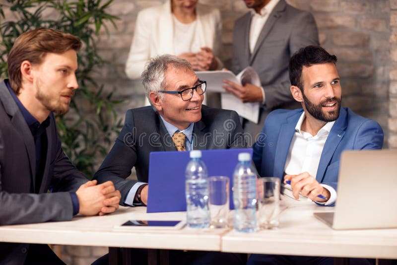 Coworkers team in working process on meeting stock photo
