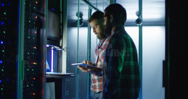 Coworking engineers setting mining farm hardware royalty free stock images