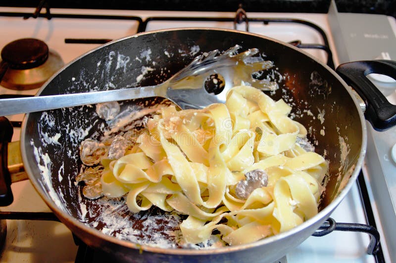 Cozinhando a massa de Tagliatelle imagem de stock Cozinhando a massa de Tagliatelle imagem de stock