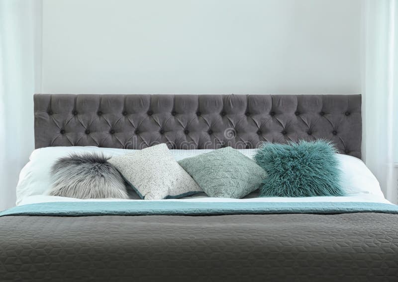 Cozy Bed with Different Pillows and Plaid. Idea for Interior Decor