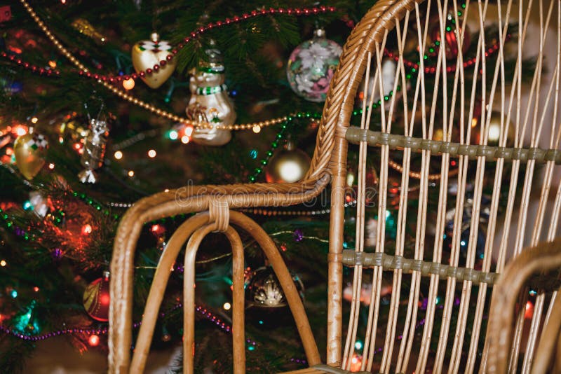 Wicker Chair on Background of Christmas Tree with Toys Stock Photo