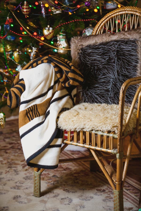 Wicker Chair on Background of Christmas Tree with Toys Stock Photo