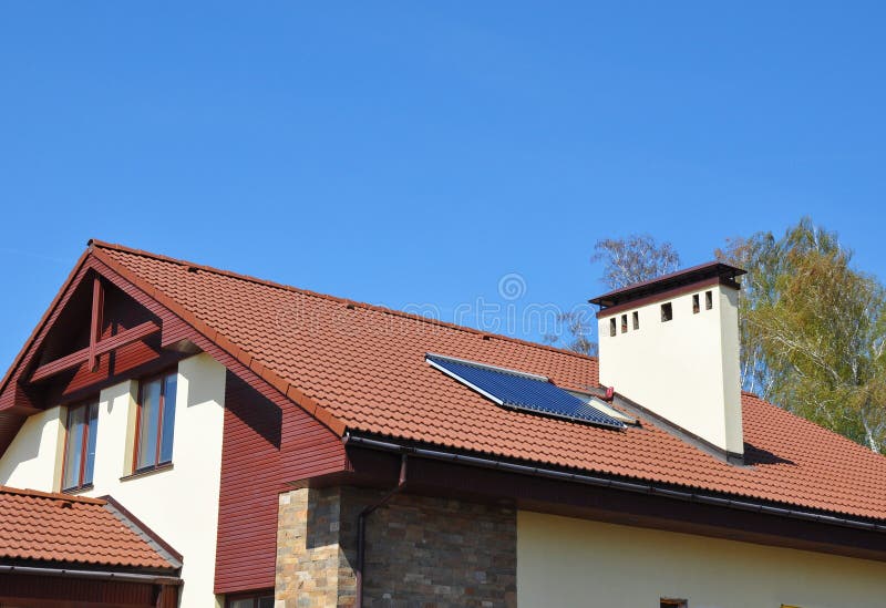 Cozy house Roofing with Vacuum Solar Water Panel Heating, Solar Panels, Skylights Outdoor. Energy Efficiency New Passive House Building Concept Exterior. Cozy stock images Cozy house Roofing with Vacuum Solar Water Panel Heating, Solar Panels, Skylights Outdoor. Energy Efficiency New Passive House Building Concept Exterior. Cozy stock images