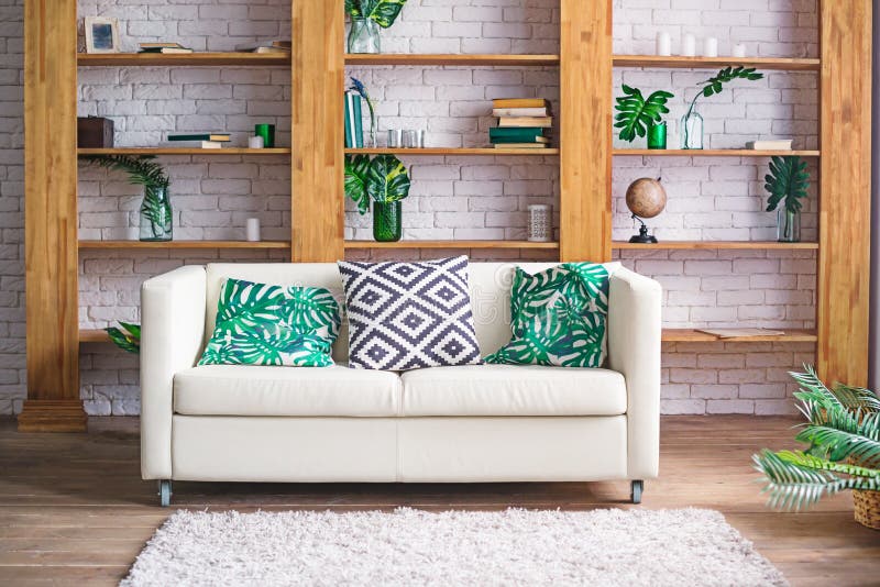 Cozy light room with plants, white sofa and stylish furniture in scandinavian style. Living room interior concept. Selective focus royalty free stock photo Cozy light room with plants, white sofa and stylish furniture in scandinavian style. Living room interior concept. Selective focus royalty free stock photo