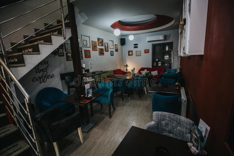 Cozy Modern Restaurant Interior with Comfortable Soft Chairs and Wall