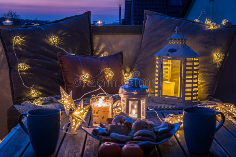 Cozy sitting area with coffee and cookies on a balcony in beautiful sundown light