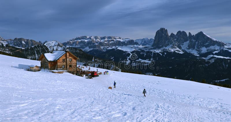 A cozy wooden cabin in a snowy mountain Dolomite Alps in the background. stock video