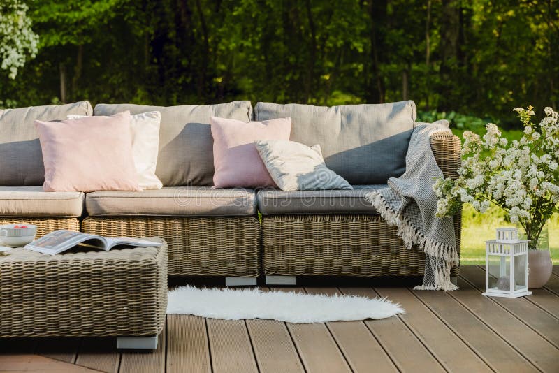 Wooden Terrace with Grey Sofa with Pastel Pink Pillows and Blanket ...