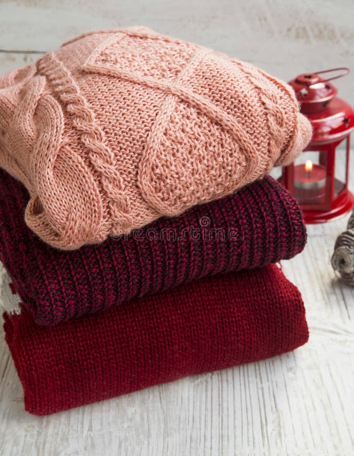 Cozy Fluffy Woolen Sweaters for Winter Time with Christmas Lantern in the Background. Winter woolen clothes stock images, royalty-free photos and pictures