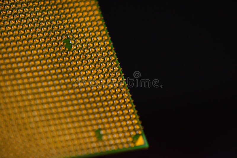 CPU - central processor unit upside-down on a black background. Pins. Copy space stock photo