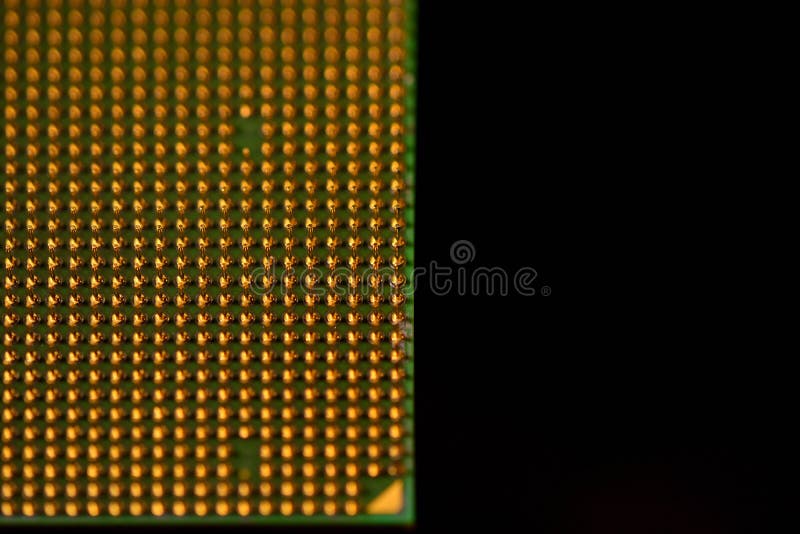CPU pins. Central processor unit upside-down on a black background. Copy space on the right royalty free stock photography