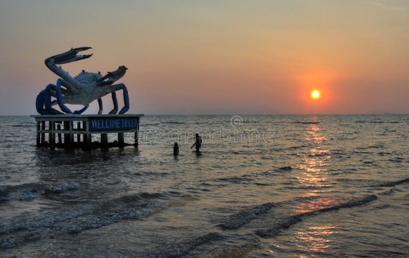 Crab statue and swimmers at Kep Beach