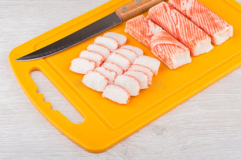 Crab Sticks and Kitchen Knife on Orange Cutting Board Stock Image Image of orange, objects