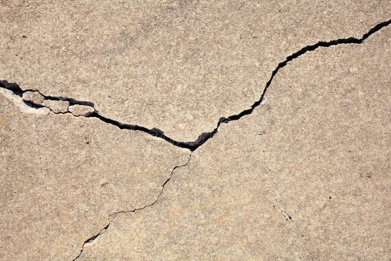 Close-up of a damaged concrete block with a crack across. Close-up of a damaged concrete block with a crack across