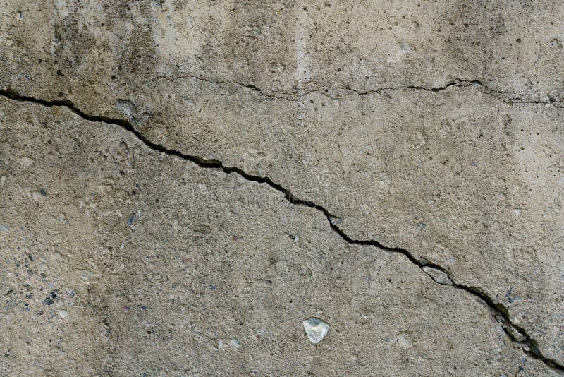 Cracked concrete slab. Wall made of cement with crack. House foundation repair. Texture surface or background