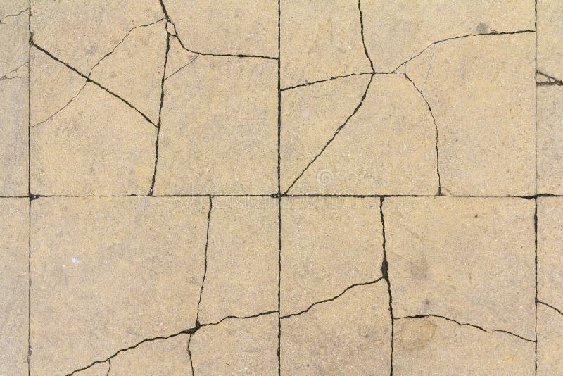 Cracked concrete tile texture. City pavement crack background. Abstract stone brick pattern. Street sidewalk texture