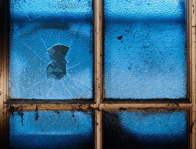 Cracked hole in old grungy window