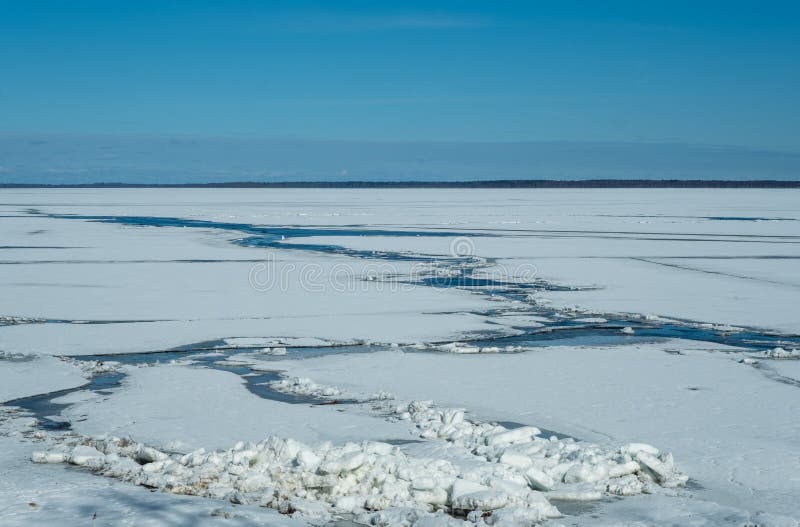 Cracked lake ice on a clear sunny very cold day royalty free stock images