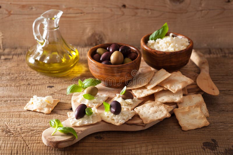 Crackers with soft cheese and olives. healthy appetizer royalty free stock photography Crackers with soft cheese and olives. healthy appetizer royalty free stock photography