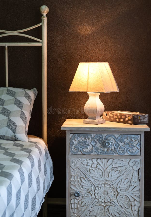 Craft Bedside Lamp on a Bedside Table in Bedroom. Cozy Bedroom Interior