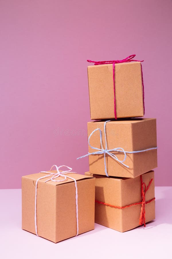 Craft Cardboard Gift Boxes on the Solid Pink Background. Holiday Stock